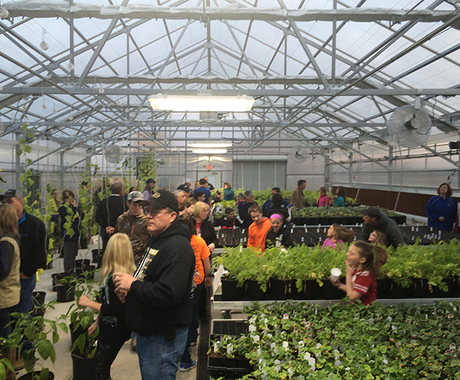 People touring school greenhouse