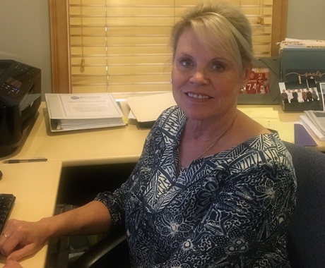 Patty Plugge at a desk