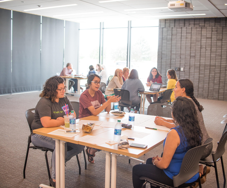 Women having a conversation, sitting around a table