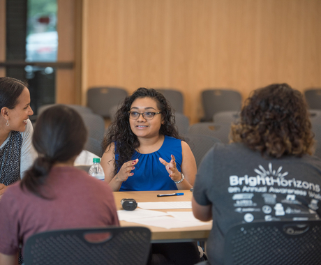Woman speaking to others at table