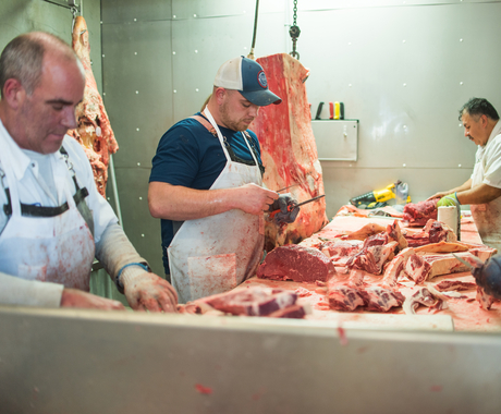 men working with butchered meat