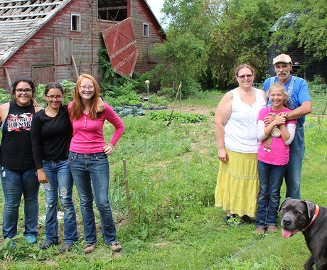 Family in front of barn with dog