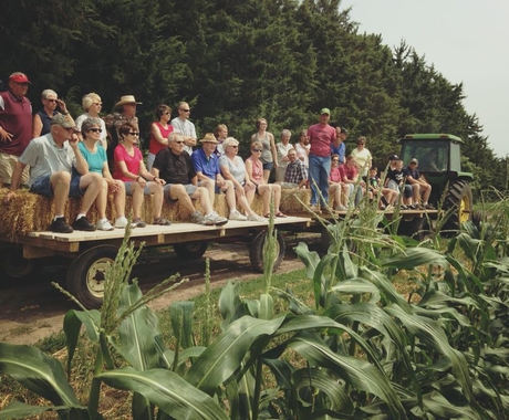 People on a hayrack on a farm tour