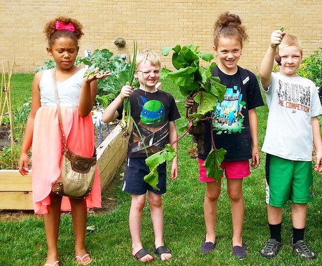 Children holding up lettuce