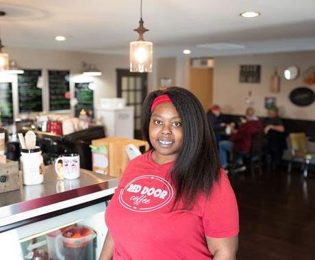 Woman stands in small coffee shop