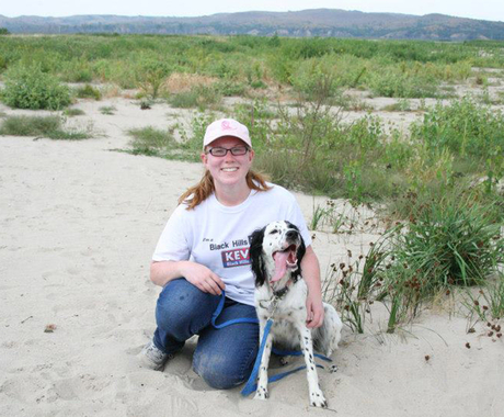 Woman with dog in sand