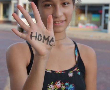 Girl with home written on her hand
