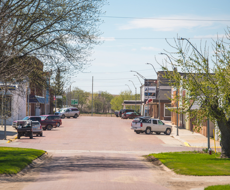 main street in a rural Community, with cars parked on both sides