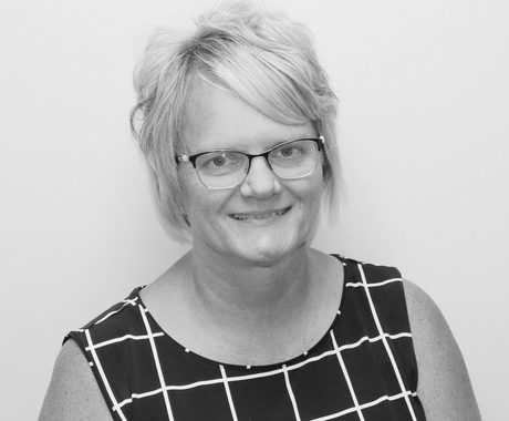 woman with glasses posing and smiling
