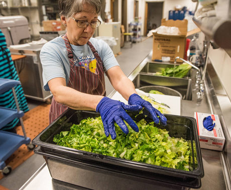 School cafeteria worker with local lettuce