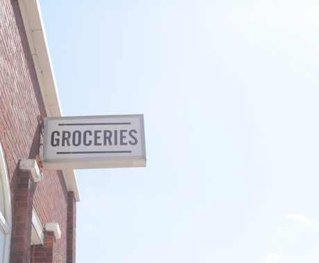 sign on the side of a grocery store building