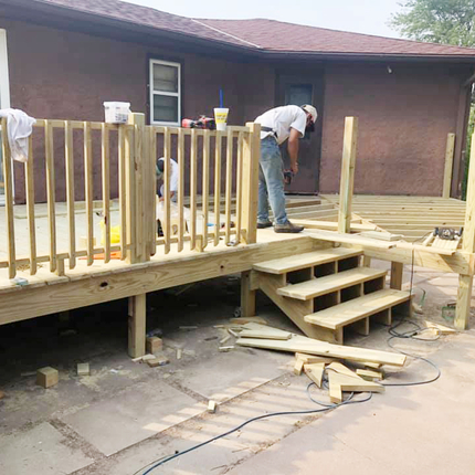 Deck on the back of a house under construction with new wood