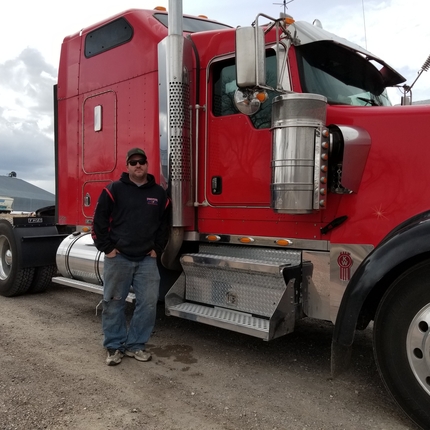 Man in front of semi-trailer truck