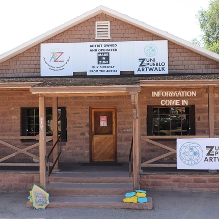 Zuni Pueblo Artwalk building made out of brick with three stairs going to main entrance 