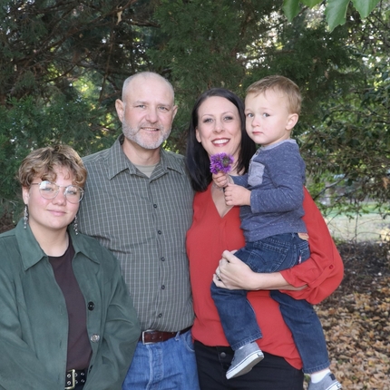 Family of four poses for picture