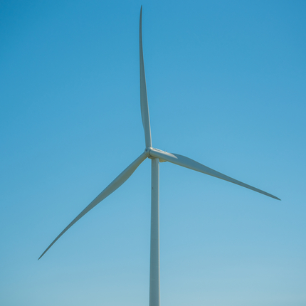 Wind turbine with blue sky in the background.