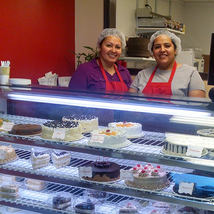 Two women behind bakery counter