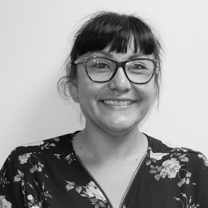 Woman with glasses smiling, headshot