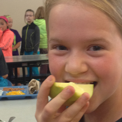 Girl biting into apple