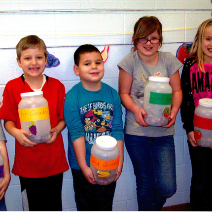 Students with jars of pennies