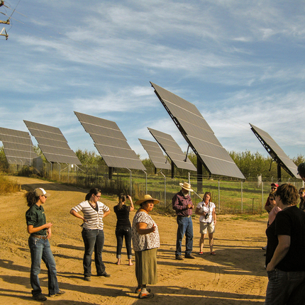 Solar array with people in front of it