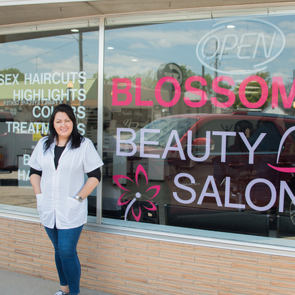 woman posing in front of storefront