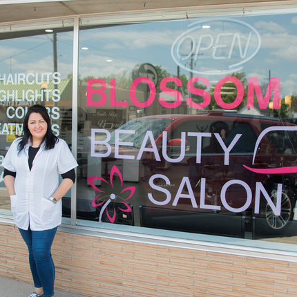 woman posing in front of storefront