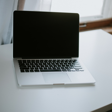 apple laptop on white desk
