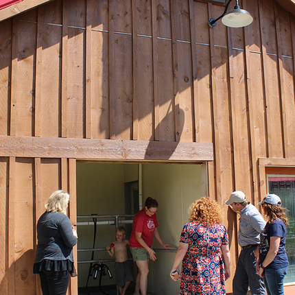 Group of people in front of milking barn