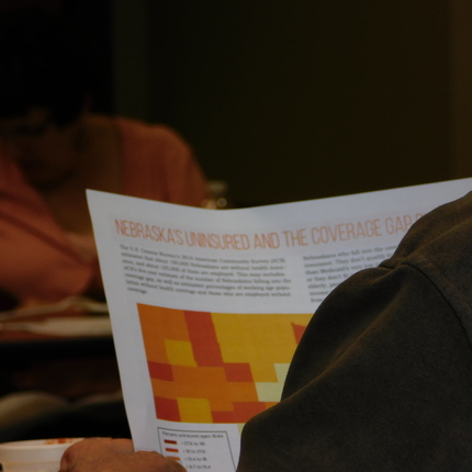 Looking over someone's shoulder at a health care fact sheet
