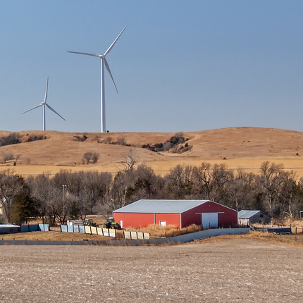 Farm place with wind towers in background