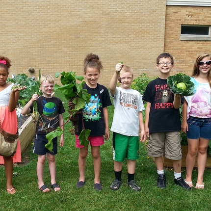 Children holding vegetables