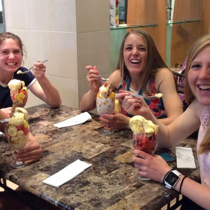 Four teenage girls eating at restaurant