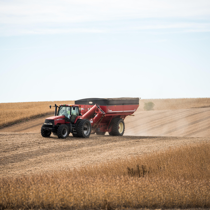 Tractor with grain cart during harvest
