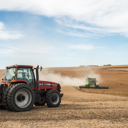 Grain cart and combine harvesting a bean field