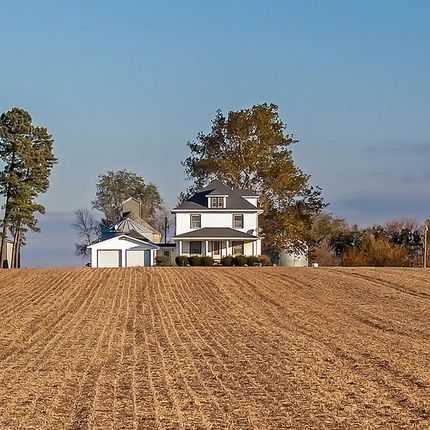 Rural home with harvested field out front