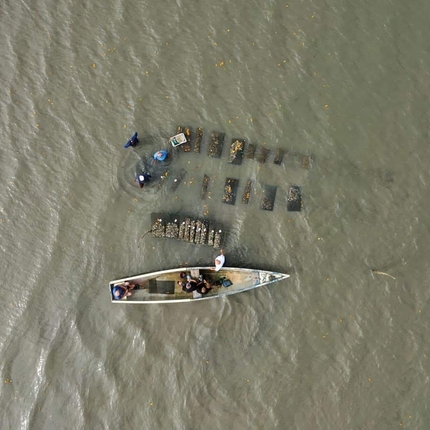 A boat and other apparatus in the ocean, the photo is taken looking down from the sky