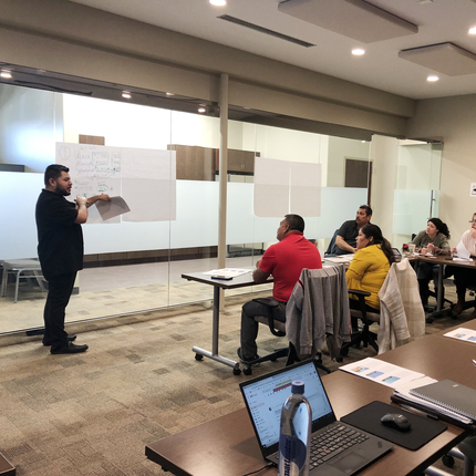 man in front of group teaching