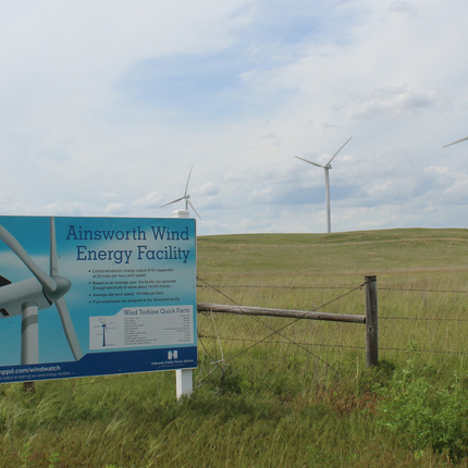 Sign for wind energy facility with wind turbines behind