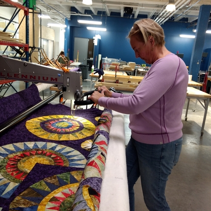 Woman working on quilt