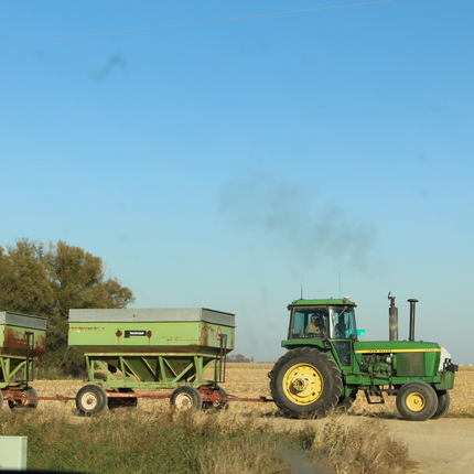 Tractor with grain cart during harvest