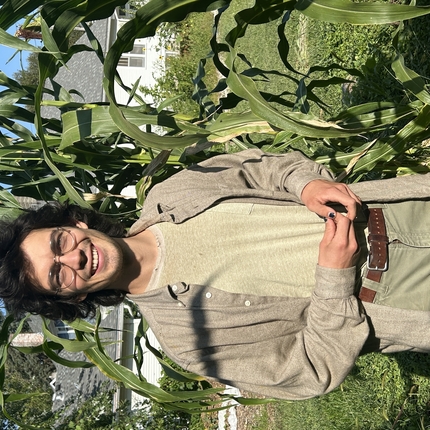 James Keeley stands in front of some corn 