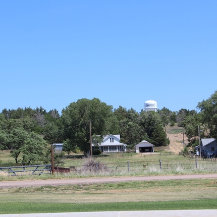 Rural community water tower and farm place