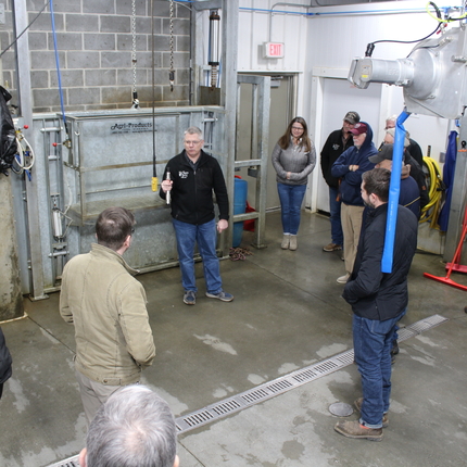 Group of people touring a meat processing facility 