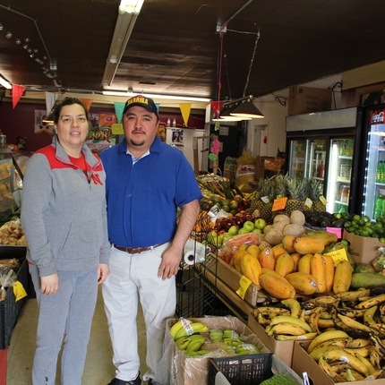 Woman and man business owners in grocery store