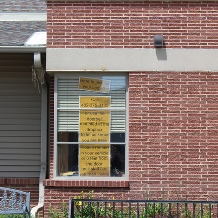 Window of rural library with instructions on picking up books