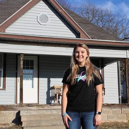 Woman standing in front of house
