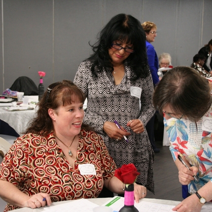 Three women networking at a conference