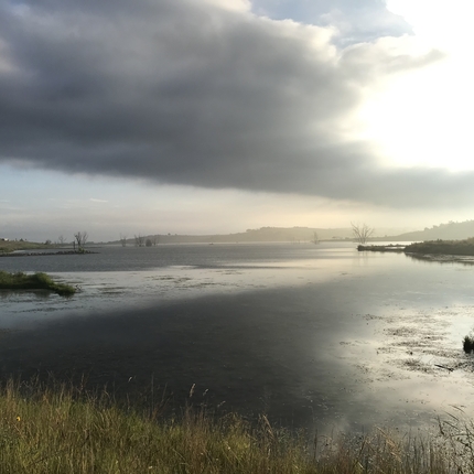Lake from shoreline, with mist over the lake