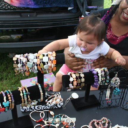 Woman with baby at booth with jewelry